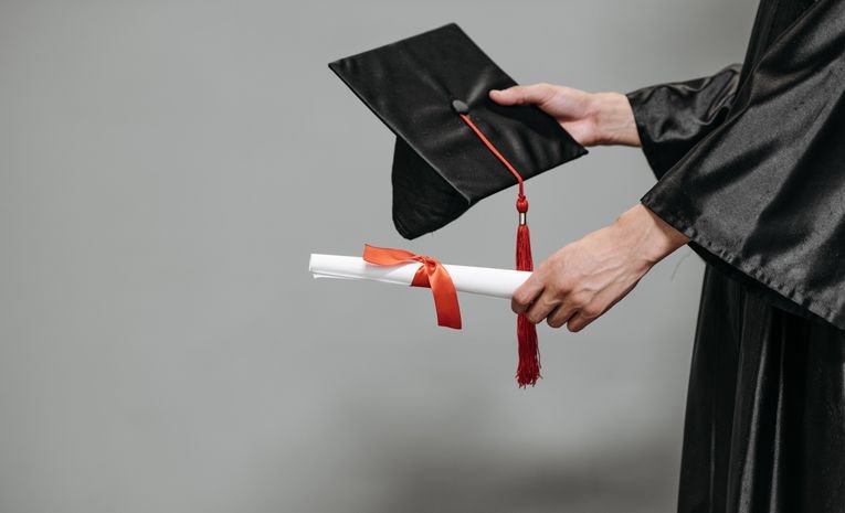 Graduate holding a diploma after completing an Access to Higher Education course
