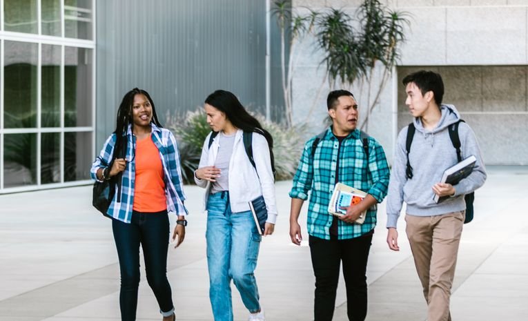 A university student walking on campus, relevant to starting a foundation year before a degree