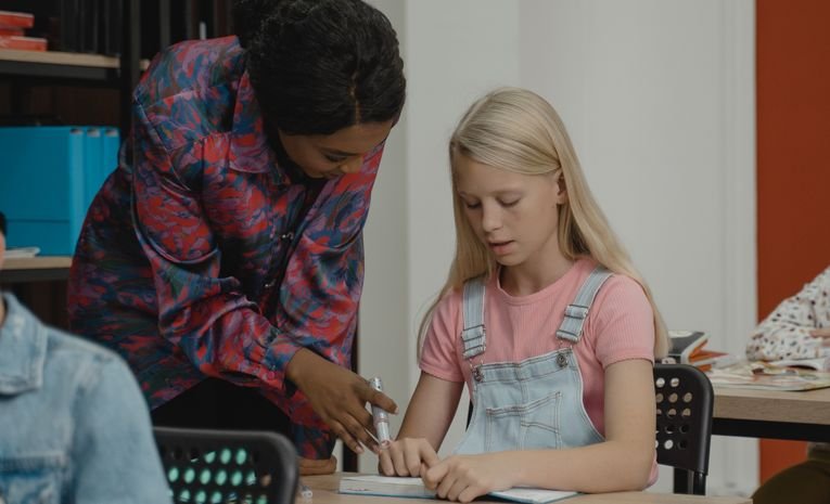 A tutor giving one to one support to a pupil, relevant to whether private tutoring is worth it
